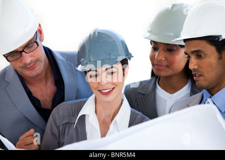 International architects studying a blueprint Stock Photo