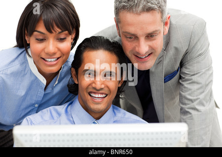 Positive business group working at a computer Stock Photo
