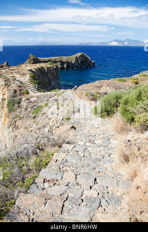 Path to the headland on the island Panarea of Aeolian Islands. Island Lipari and Vulcano in the distance. Stock Photo