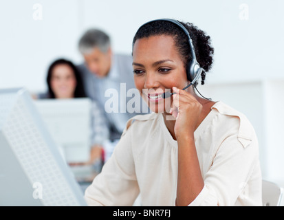 Confident businesswoman talking on headset Stock Photo