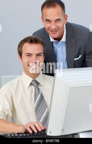 Assertive business partners working together at a computer Stock Photo