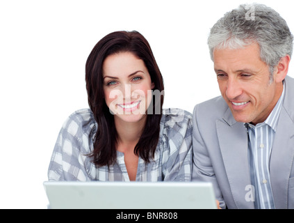 Two positive business co-workers using a laptop Stock Photo