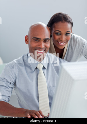 Portrait of two colleagues working at a computer Stock Photo