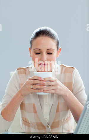 Beautiful businesswoman drinking a coffee Stock Photo