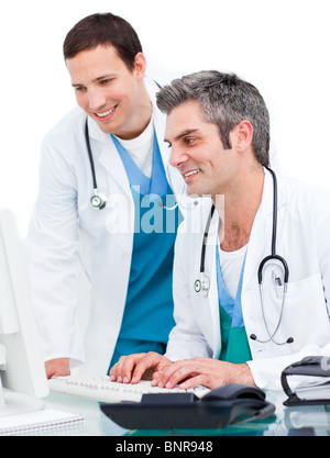 Smiling doctors working at computer Stock Photo