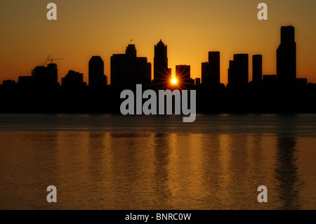 Stunning orange sunrise over downtown Seattle, WA skyline with all buildings in silhouette, June 2008. Stock Photo