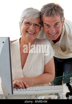 Happy senior couple using a computer Stock Photo