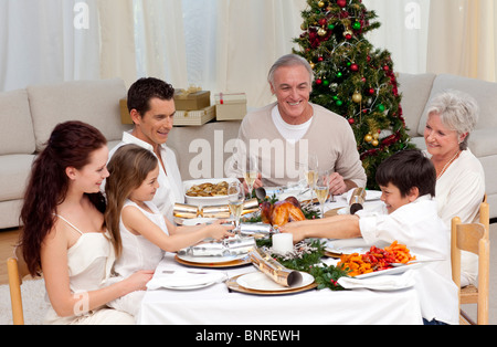 Brother and sister pulling a Christmas cracker at home Stock Photo