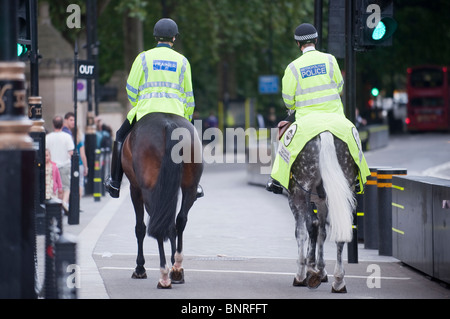 Metropolitan police officers regularly patrol the streets of London on horseback. Stock Photo