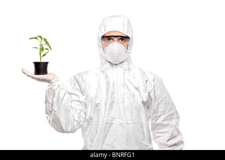 A man in uniform holding a plant Stock Photo