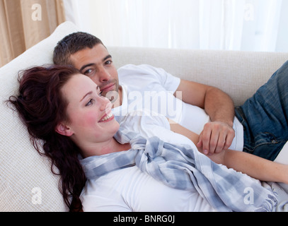 Couple lying on sofa Stock Photo