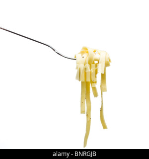 Pasta ribbons tossed in olive oil, salt and pepper on fork isolated against white. Stock Photo