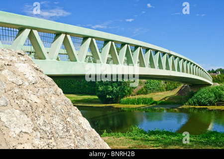 Modern metal single span arch bridge over river - Preuilly-sur-Claise, France. Stock Photo