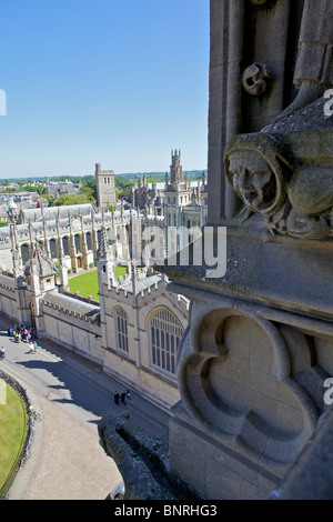 Gargoyle on the tower of the University Church of St Mary the Virgin in Oxford, England with All Souls College in the distance. Stock Photo
