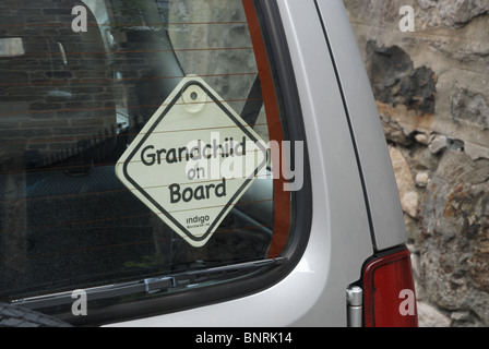 'Grandchild on Board' sticker on car window. Stock Photo