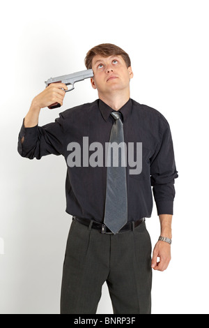 A young man tries to shoot himself, isolated on a white background Stock Photo