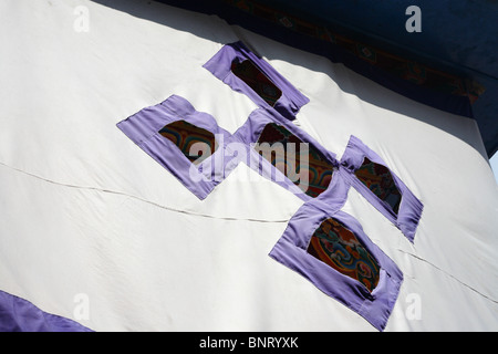 A decorative buddhist flag in the Rumtek Monastery near Gangtok in Sikkim, Northern India. Stock Photo