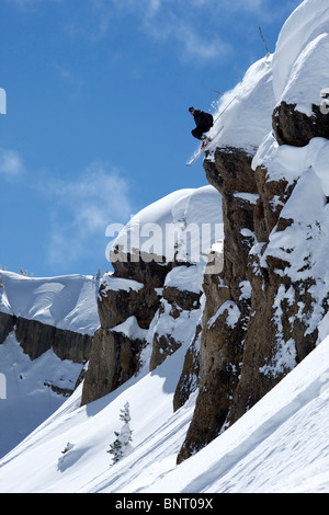 A man skis off a cliff in Wyoming. Stock Photo