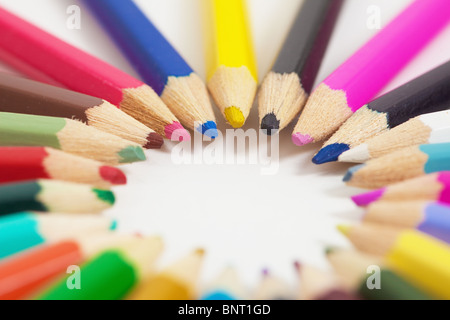 Several children's colored pencils arranged in a circle Stock Photo