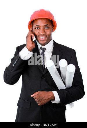 Friendly architect with blueprints speaking on a mobile Stock Photo