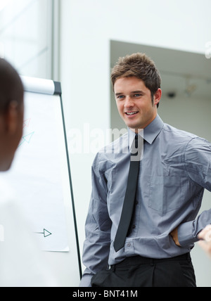 Smiling young businessman giving a presentation Stock Photo