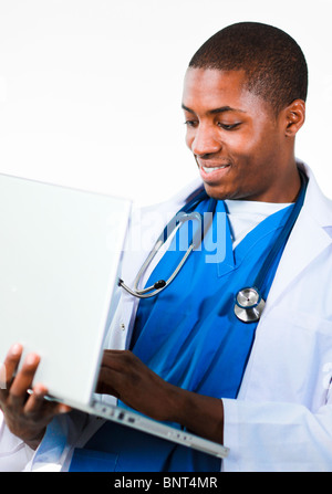 Friendly Afro-American doctor working on a laptop Stock Photo