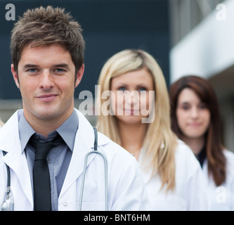 Handsome young doctor leading his team Stock Photo
