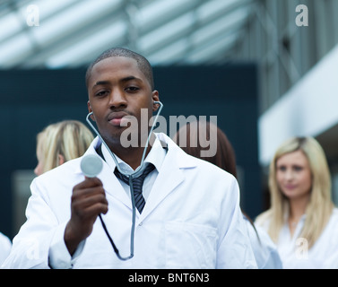 Handsome Afro-American doctor leading his team Stock Photo