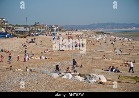 People enjoying the beach on a hot sunny day in Worthing, West Sussex, UK