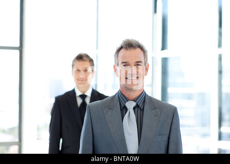 Smiling businessman standing in front of the camera Stock Photo