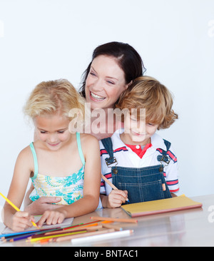 Children doing homework with their mother Stock Photo
