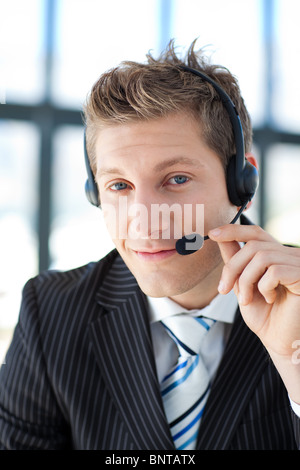 Young businessman with a headset on in a call center Stock Photo