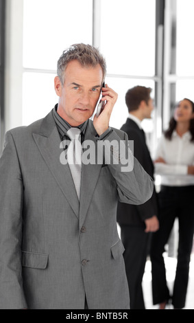 Senior Businessman talking on cellphone Stock Photo