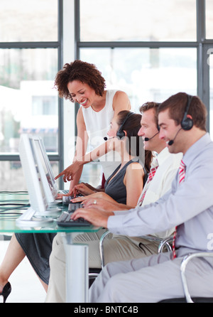 Female leader managing he team in a call center Stock Photo