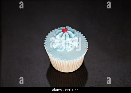 Cupcakes with blue icing on a black marble surface Stock Photo