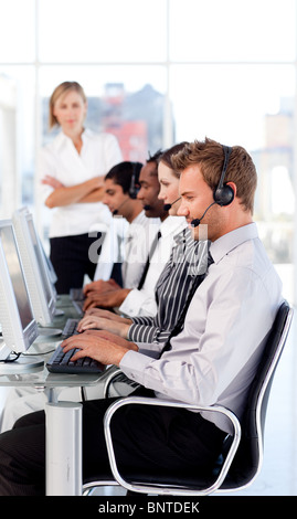 Female leader managing her team in a call center Stock Photo