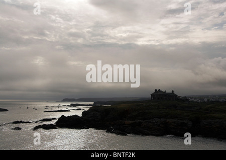 House silhouetted against the sky, overlooking the coast, Trearddur Bay, Anglesey, North Wales, UK Stock Photo