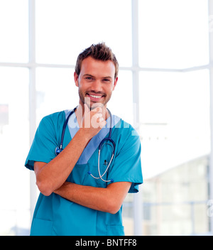 Handsome young doctor isolated smiling at the camera Stock Photo