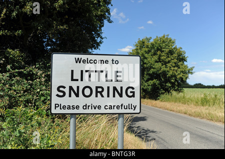 Welcome to Little Snoring Please Drive Carefully village sign in North Norfolk UK Stock Photo