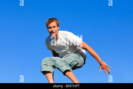 Young man jumping in the air Stock Photo