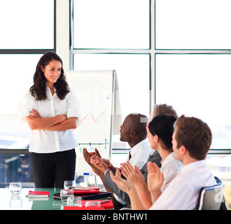 Brunette businesswoman interacting with her colleagues in a presentation Stock Photo