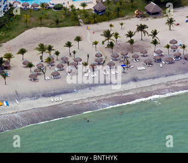 aerial view above straw umbrellas bathers boats Pacific coast Republic of Panama Stock Photo