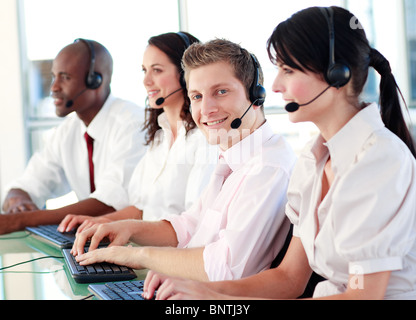 Business called centre with people on headsets Stock Photo