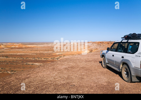 Four wheel driver overlooking the Breakaways Reserve, Coober Pedy, South Australia, AUSTRALIA. Stock Photo