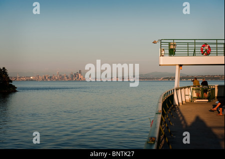 A Washington State Ferry leaves Bainbridge Island heading toward downtown Seattle, Washington on the evening commute. Stock Photo