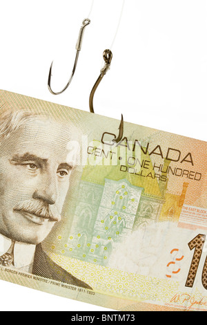 Fishing Hook and Canadian Dollar Close up Shot Stock Photo