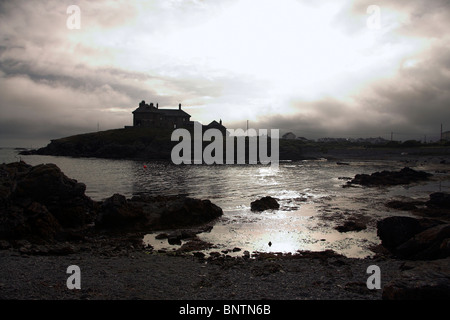 House silhouetted against the sky, overlooking the coast, Trearddur Bay, Anglesey, North Wales, UK Stock Photo