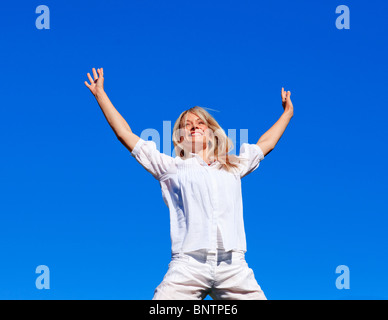 Young woman jumping outdoors Stock Photo