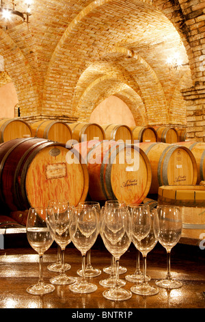 Wine aging in barrels in cellar with wine glasses. Castello di Amorosa. Napa Valley, California. Property released Stock Photo