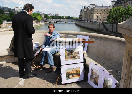 artist selling work from Pont Neuf Paris France Stock Photo